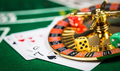 Vintage casino chips on green table with cards.