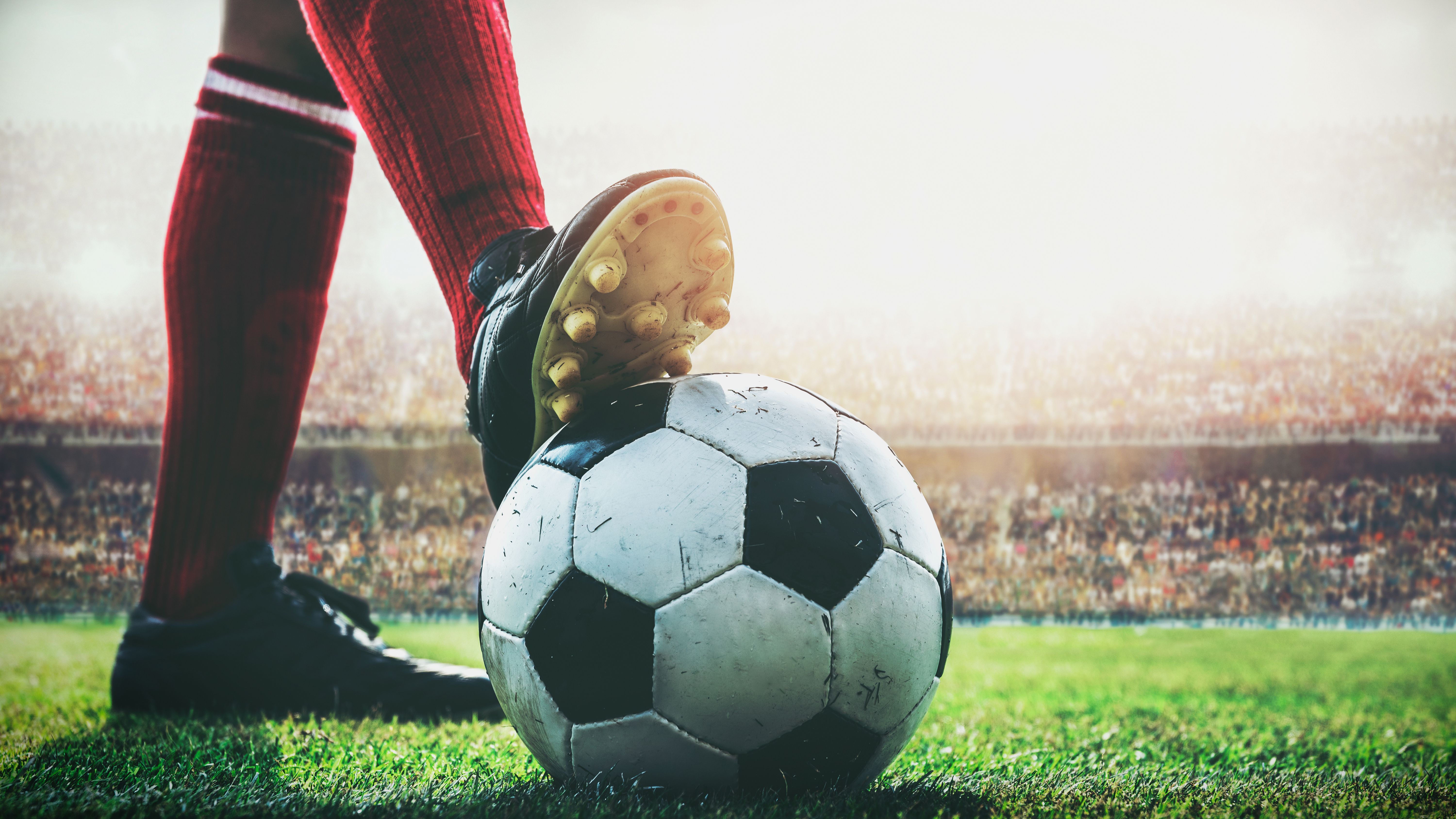 feet of soccer player tread on soccer ball for kick-off in the s