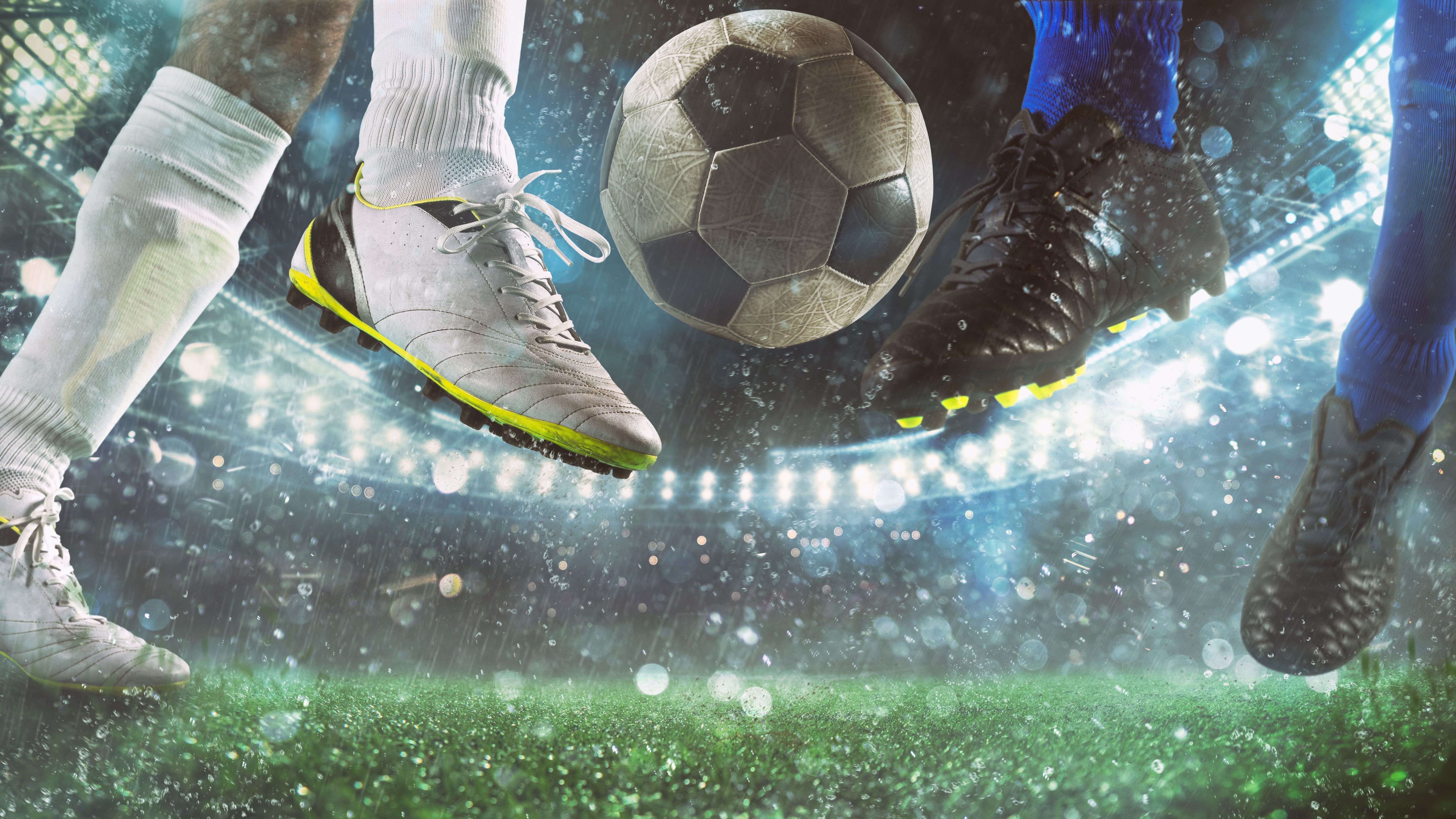 Close up of a football action scene with competing soccer players at the stadium