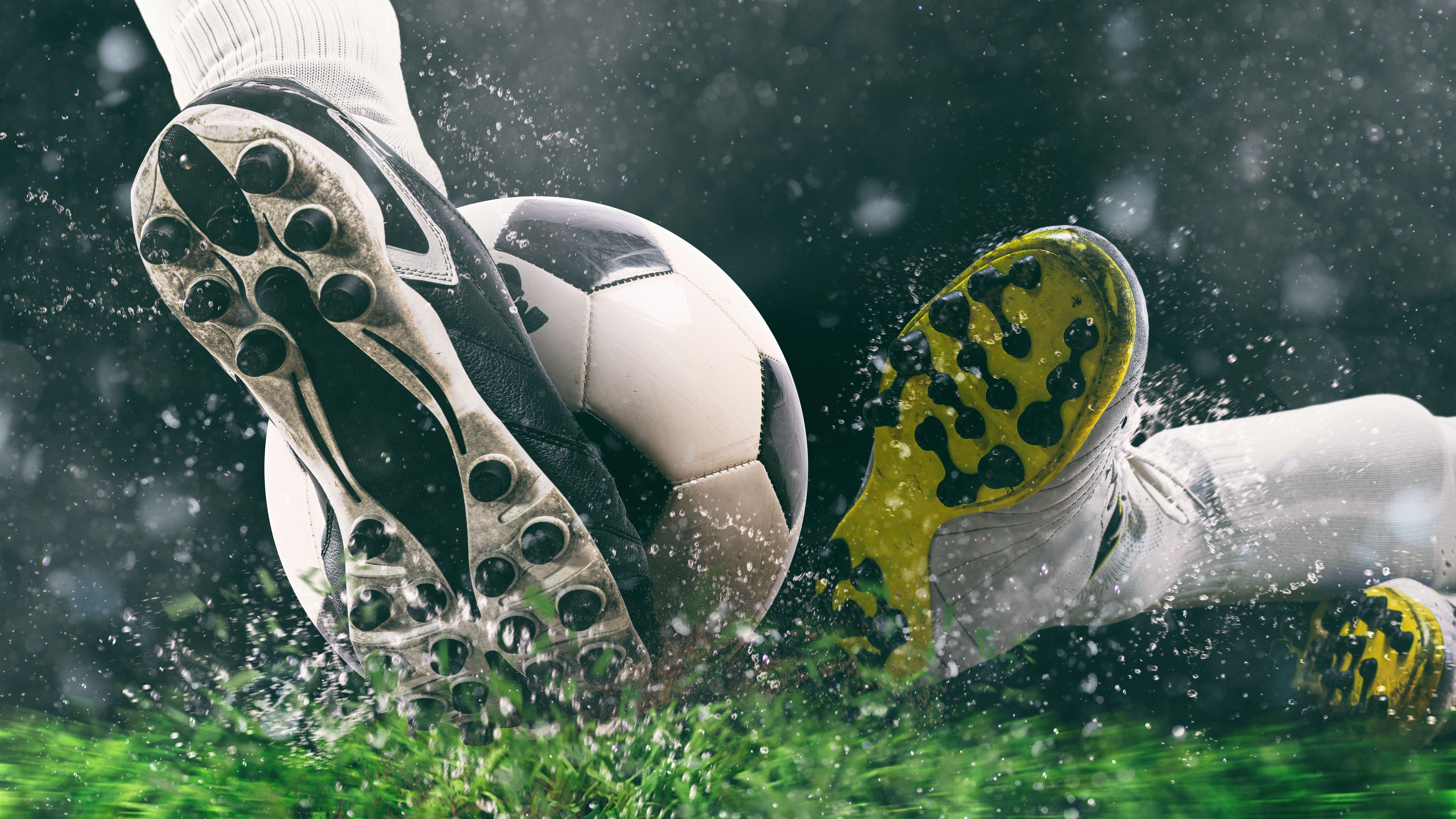 Football scene at night match with close up of a soccer shoe hitting the ball with power