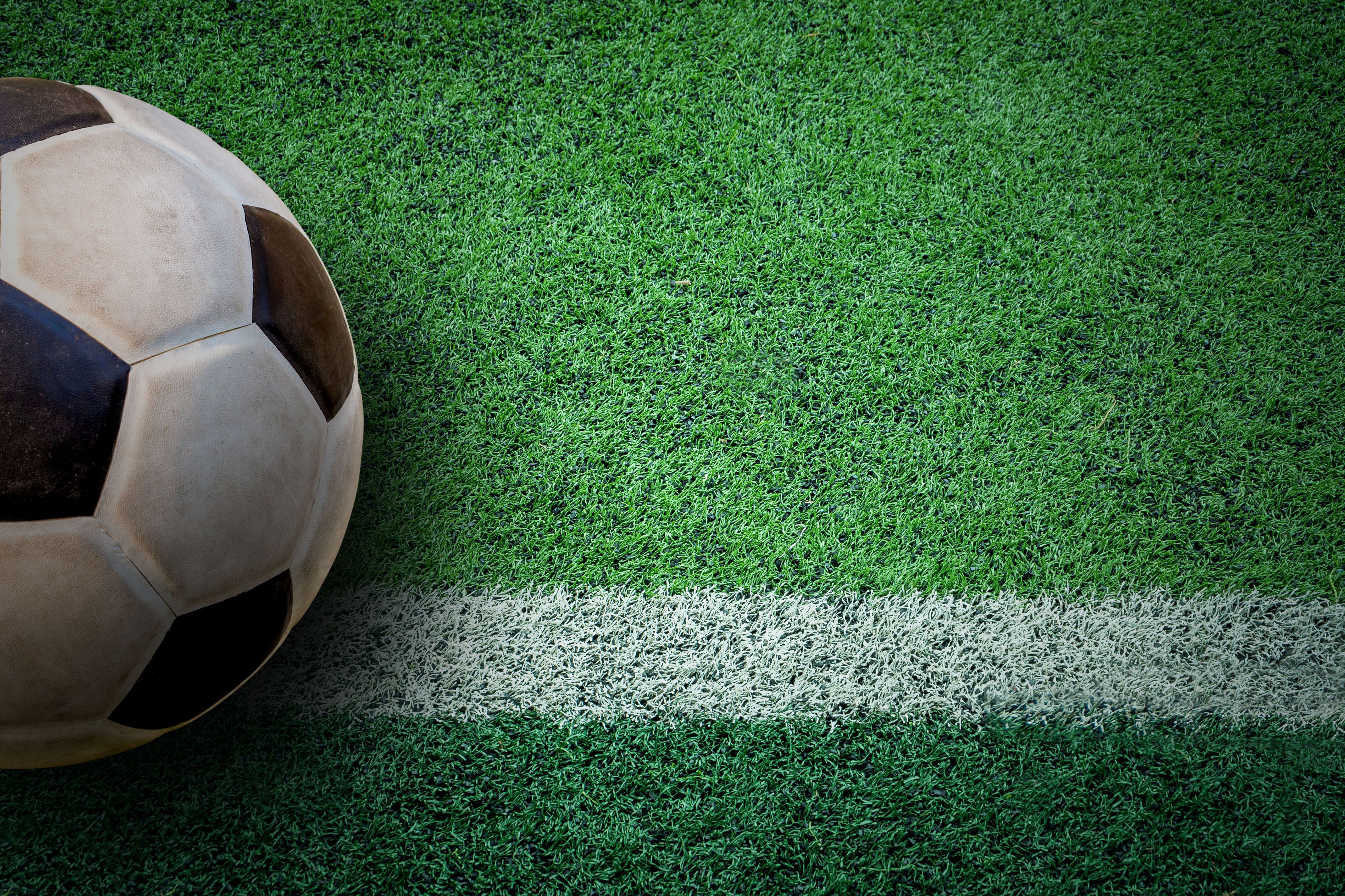 soccer ball on green artificial tur