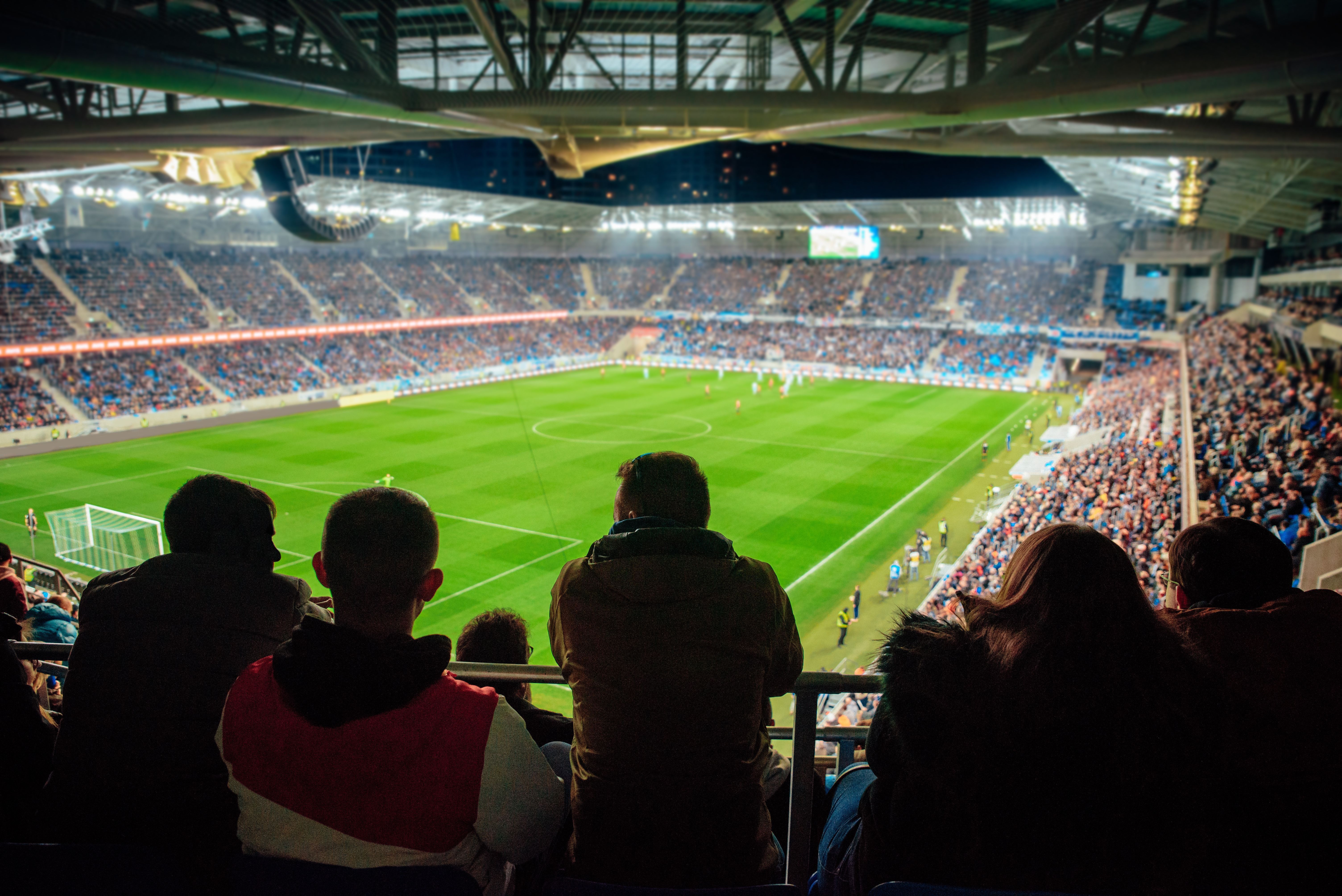 Fans watching the game at soccer stadium, football photo