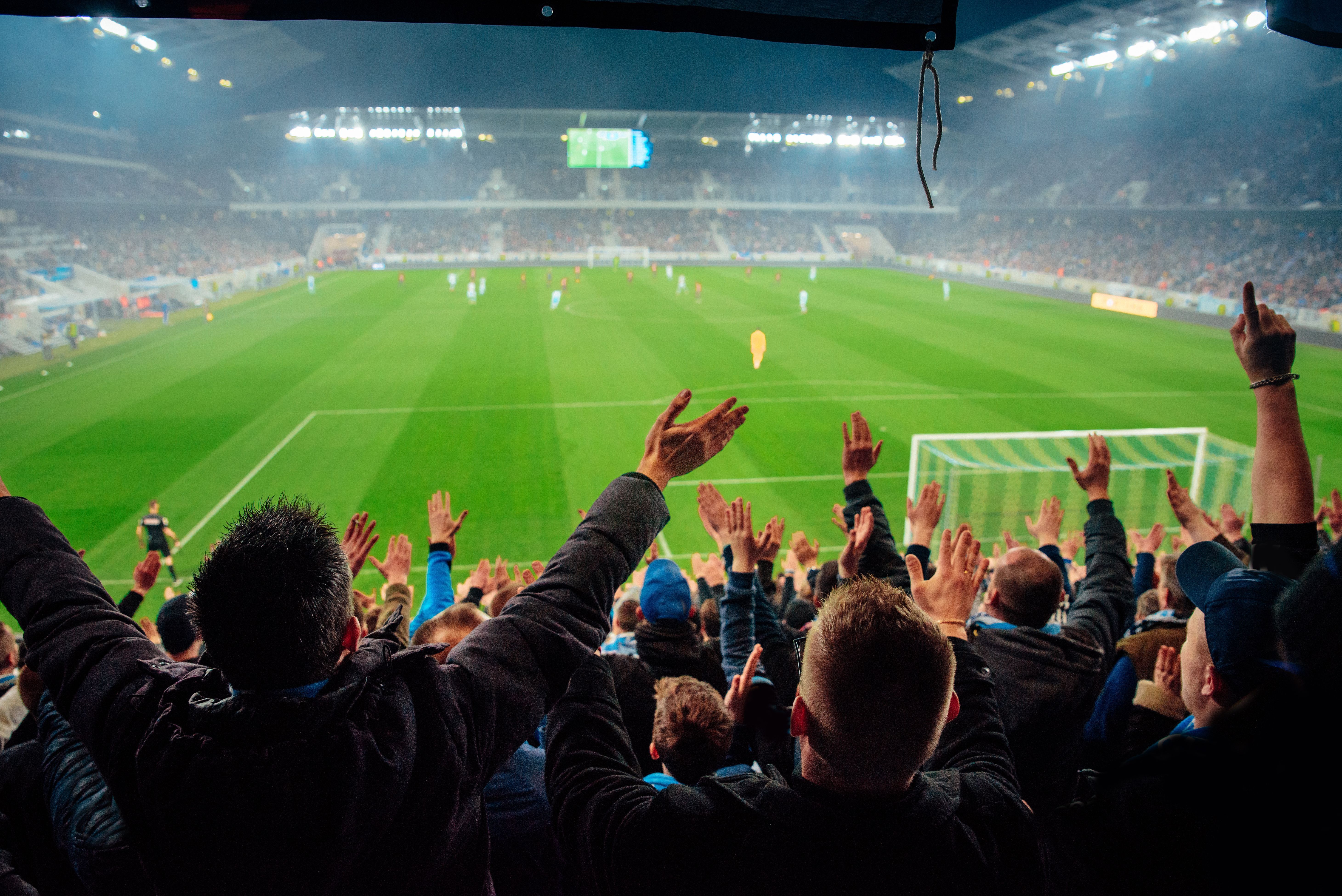 Photo – crowded soccer stadium, football fans support the team