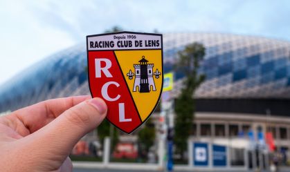 September 13, 2021, Lens, France. The emblem of the RC Lens football club against the background of a modern stadium.