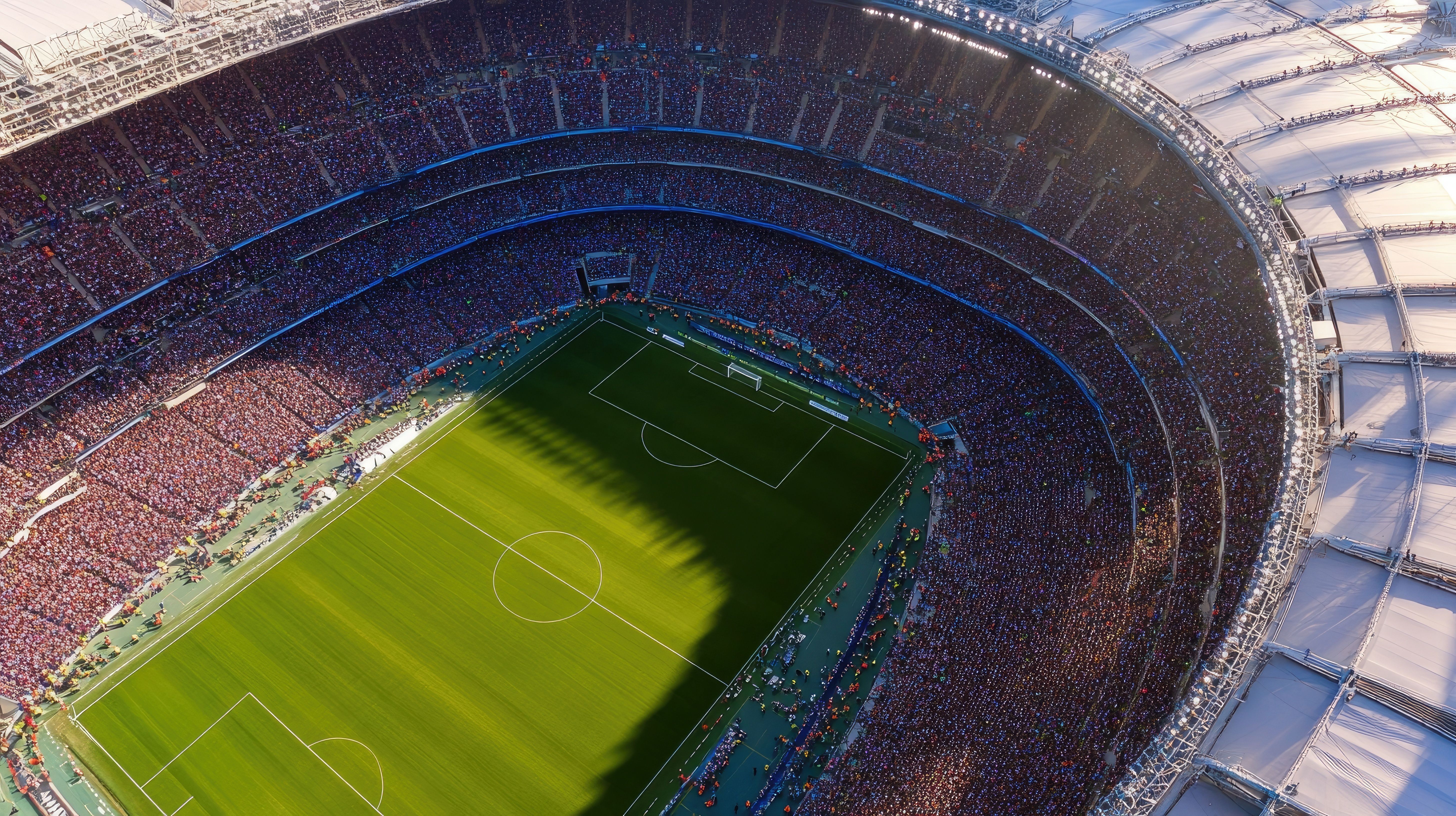 Aerial view of a football stadium packed with fans during a match