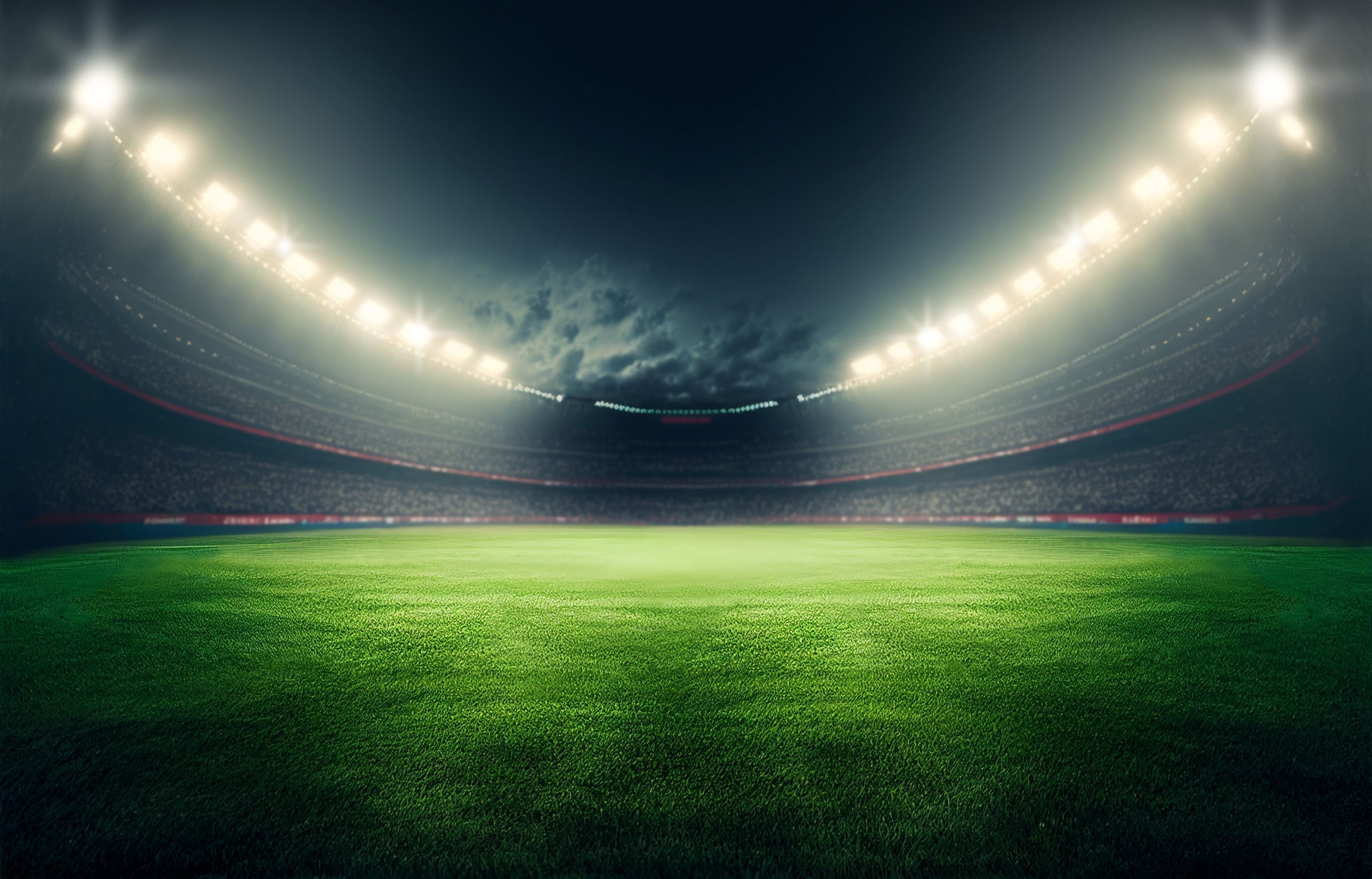 Large football stadium with lights at night.