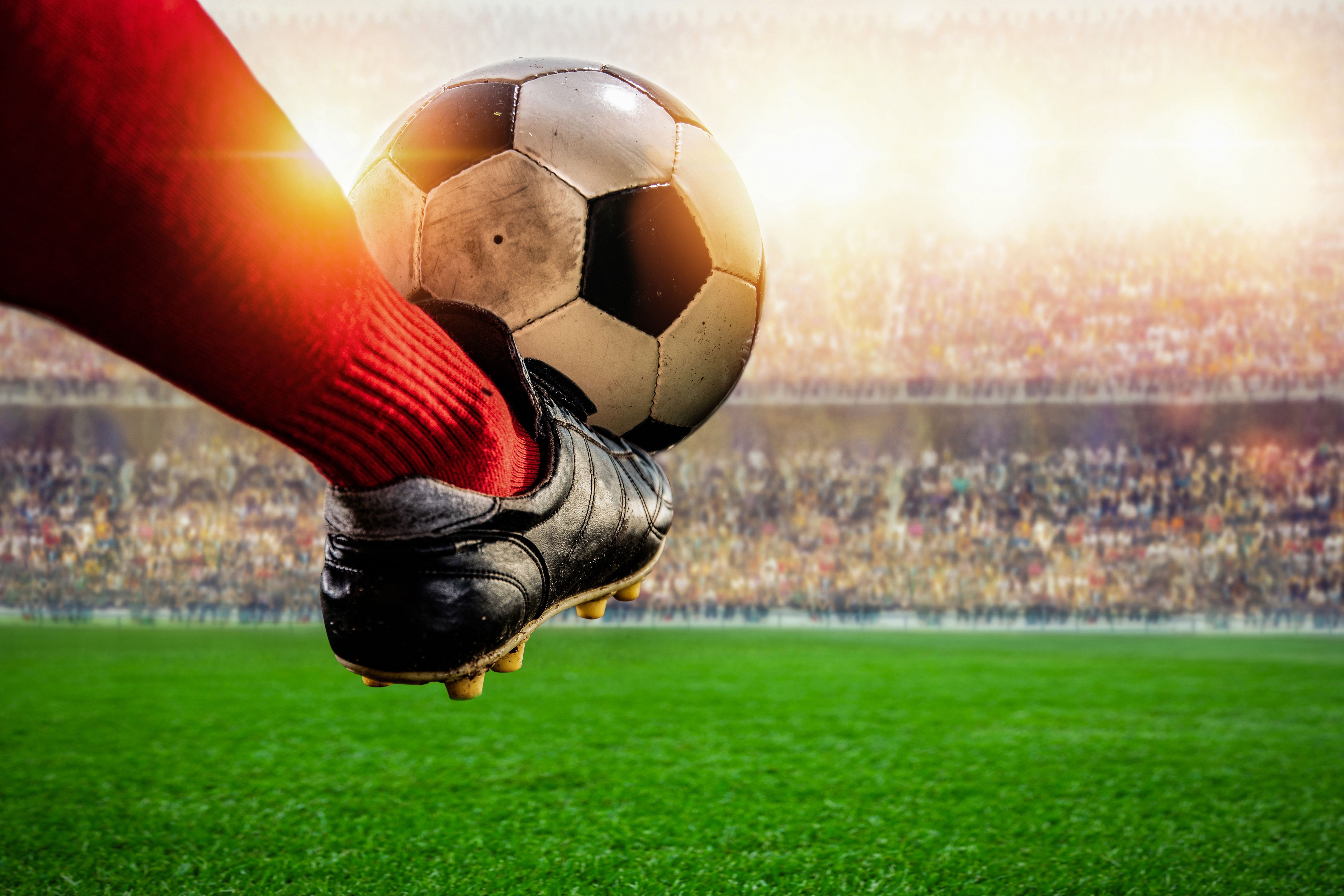 red soccer player kicking ball action in the stadium