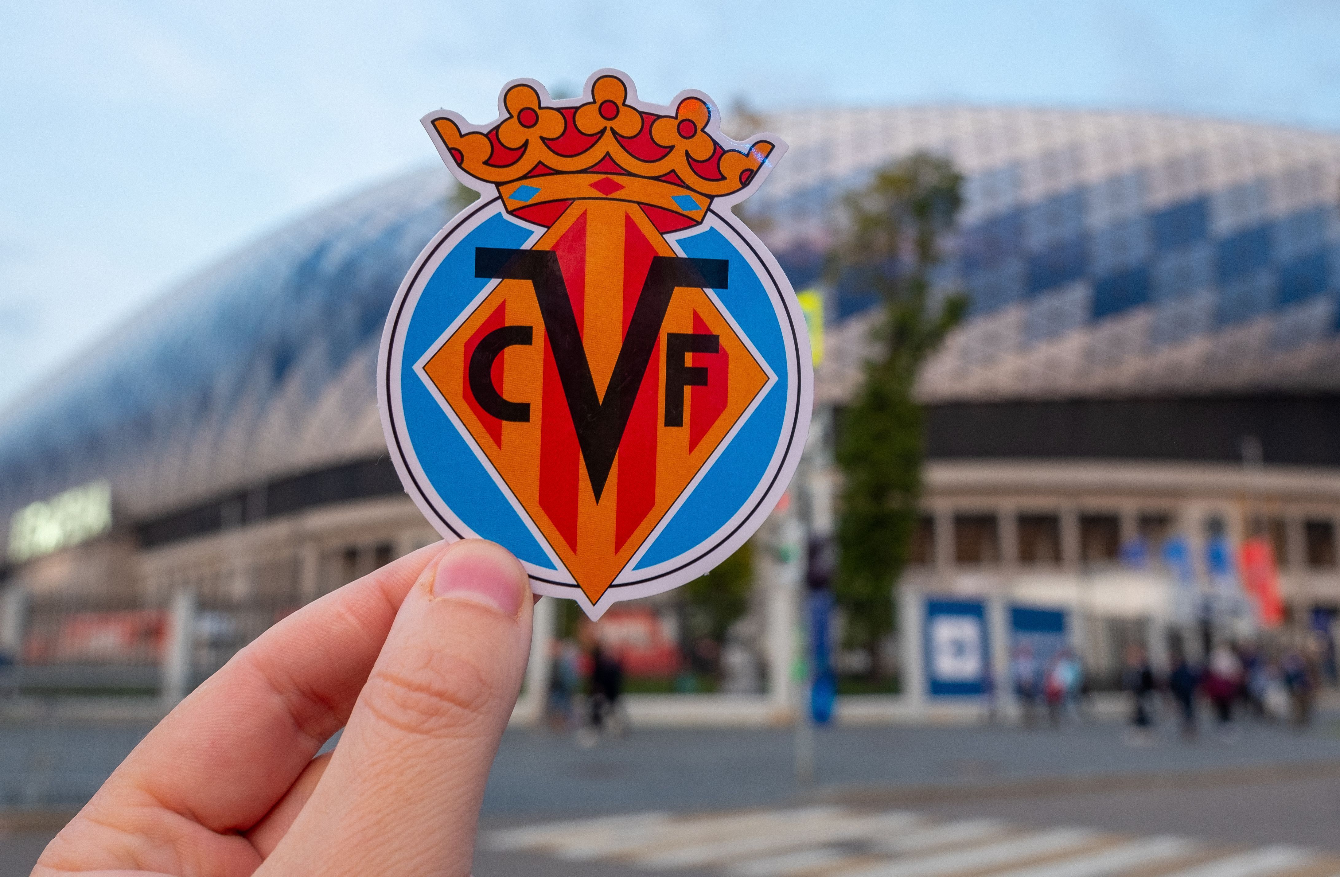 September 12, 2021, Villarreal, Spain. The emblem of the football club Villarreal CF against the background of a modern stadium.