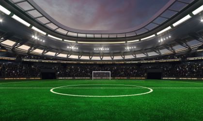 Football and soccer field at a sports stadium with shining spotlights and fans ready for the upcoming grand sporting event. Professional sports advertisement background.
