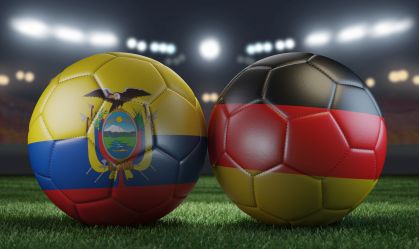 Two soccer balls in flags colors on a stadium blurred background. Ecuador vs Germany. 3D image.