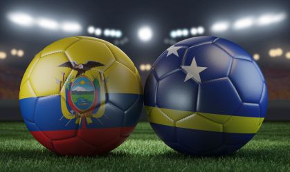 Two soccer balls in flags colors on a stadium blurred background. Ecuador and Curacao. 3D image.