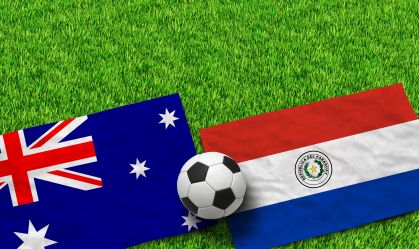 Australian and Paraguayan flags with a soccer ball on green grass field